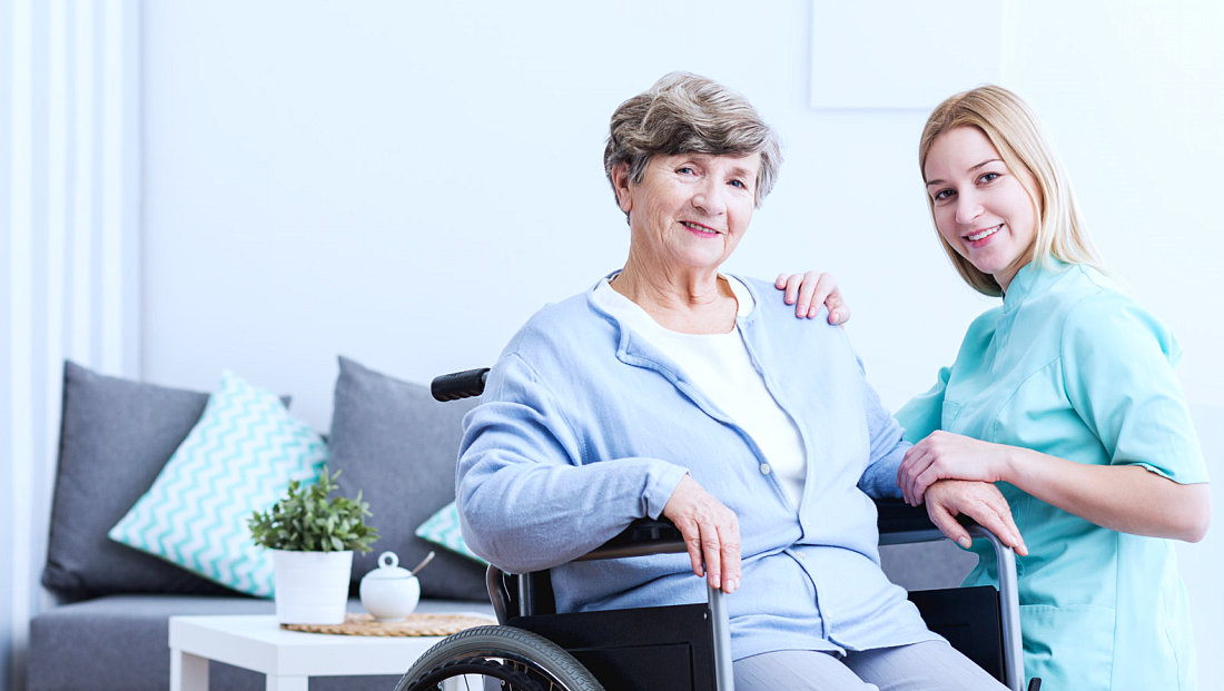 caregiver and senior woman smiling